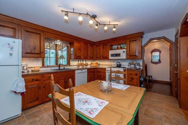 21 Overlook Dr, Chelmsford, MA 01824 - kitchen featuring white appliances, brown cabinetry, dark countertops, and backsplash