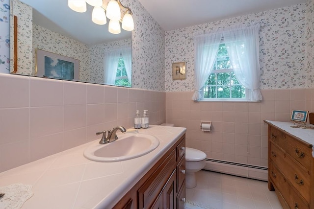 21 Overlook Dr, Chelmsford, MA 01824 - bathroom with baseboard heating, wallpapered walls, vanity, wainscoting, and tile patterned floors
