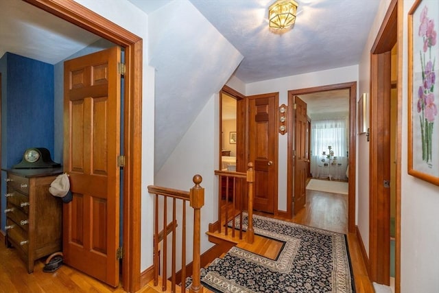 21 Overlook Dr, Chelmsford, MA 01824 - corridor featuring wood finished floors, an upstairs landing, and lofted ceiling