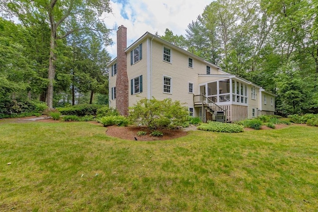 21 Overlook Dr, Chelmsford, MA 01824 - back of house featuring a sunroom, a chimney, a yard, and stairway