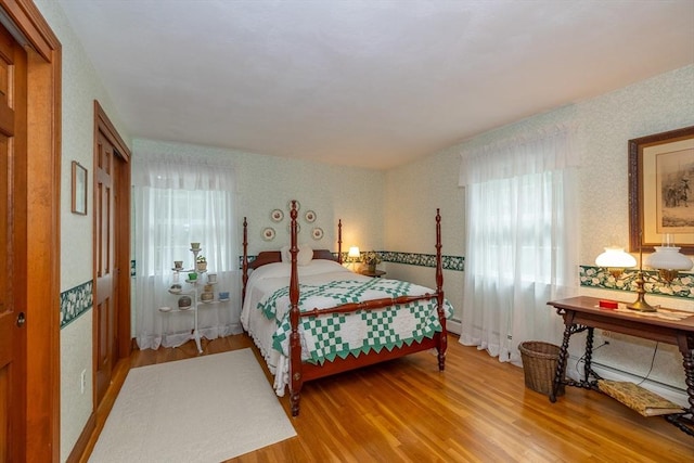 21 Overlook Dr, Chelmsford, MA 01824 - bedroom with multiple windows, wood finished floors, and wallpapered walls
