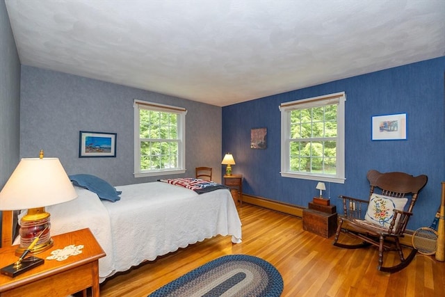 21 Overlook Dr, Chelmsford, MA 01824 - bedroom with a baseboard heating unit, wood finished floors, and multiple windows