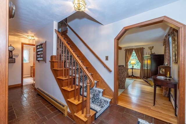 21 Overlook Dr, Chelmsford, MA 01824 - stairs featuring baseboard heating, arched walkways, and stone tile flooring