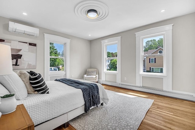 30 Forest Park Rd, Woburn, MA 01801 - bedroom with an AC wall unit, wood finished floors, baseboard heating, and recessed lighting