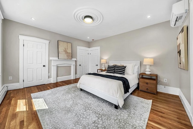 30 Forest Park Rd, Woburn, MA 01801 - bedroom with an AC wall unit and wood finished floors