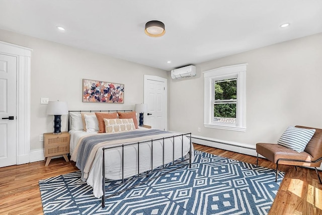 30 Forest Park Rd, Woburn, MA 01801 - bedroom with an AC wall unit, wood finished floors, and recessed lighting