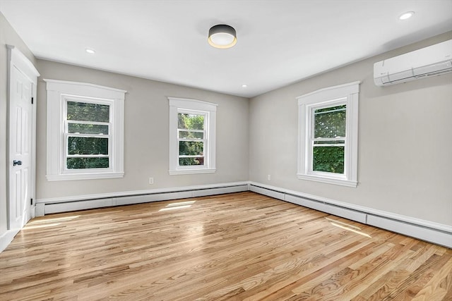 30 Forest Park Rd, Woburn, MA 01801 - empty room featuring an AC wall unit, wood finished floors, a baseboard radiator, and recessed lighting
