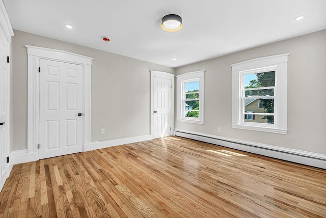 30 Forest Park Rd, Woburn, MA 01801 - unfurnished bedroom with light wood-type flooring, a baseboard radiator, and recessed lighting