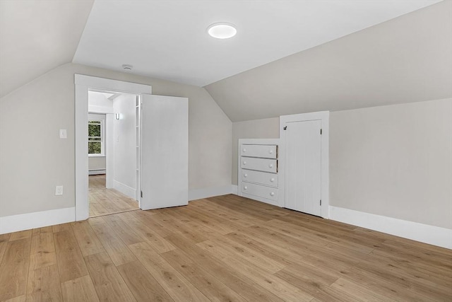 30 Forest Park Rd, Woburn, MA 01801 - additional living space with vaulted ceiling, light wood-style floors, and a baseboard heating unit