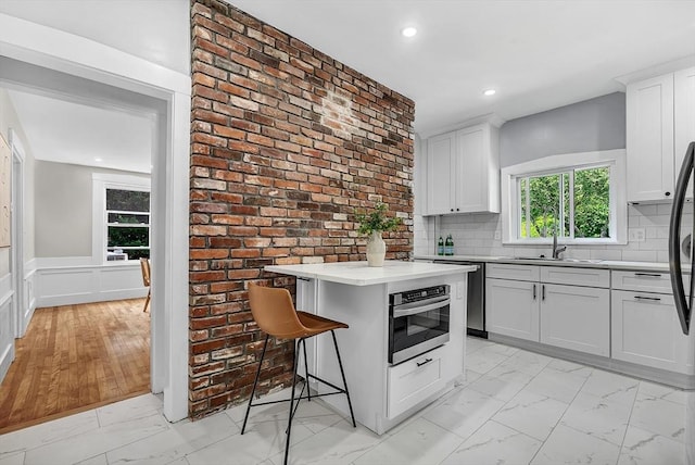 30 Forest Park Rd, Woburn, MA 01801 - kitchen featuring light marble finish floors, appliances with stainless steel finishes, light countertops, recessed lighting, and white cabinets