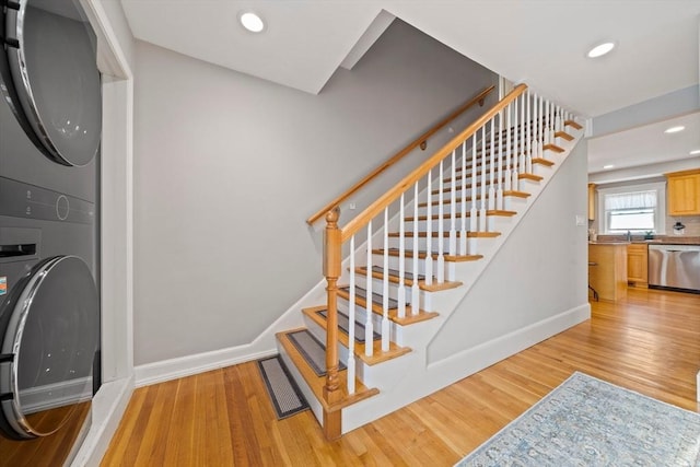 324 Mount Auburn St Unit 2, Watertown, MA 02472 - stairs with stacked washer and clothes dryer, wood finished floors, and recessed lighting
