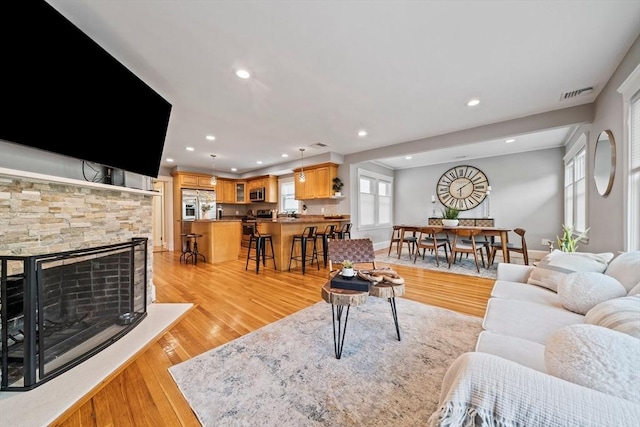 324 Mount Auburn St Unit 2, Watertown, MA 02472 - living room with recessed lighting, light wood-type flooring, and a fireplace