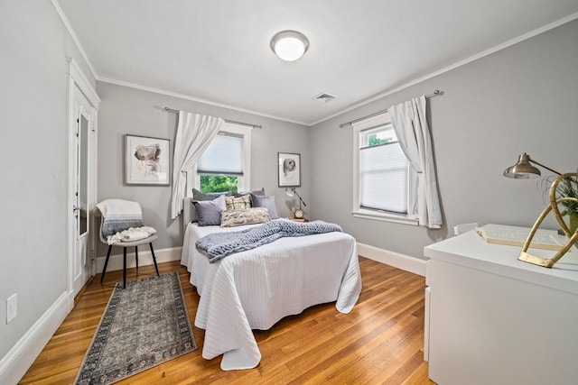 324 Mount Auburn St Unit 2, Watertown, MA 02472 - bedroom with ornamental molding, multiple windows, and light wood finished floors