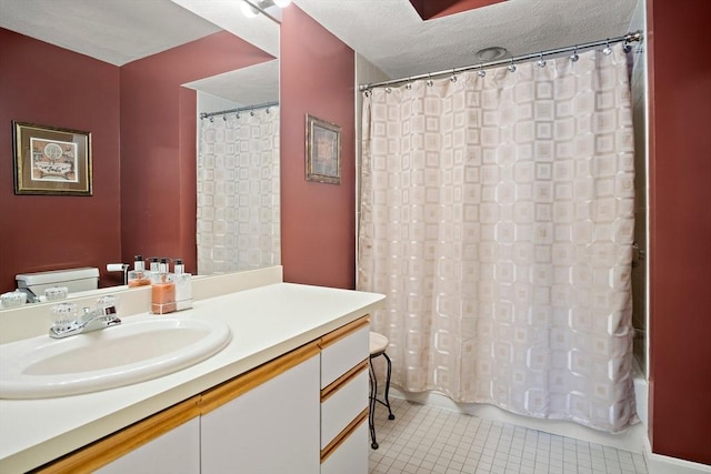 full bath with a textured ceiling, tile patterned flooring, toilet, vanity, and shower / bath combo