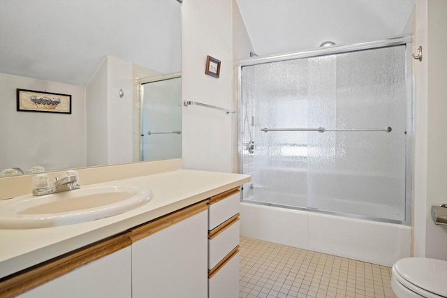 full bath with bath / shower combo with glass door, vanity, toilet, and tile patterned floors