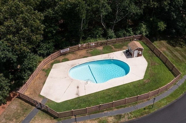 view of swimming pool featuring a fenced in pool, a fenced backyard, a patio, and a lawn