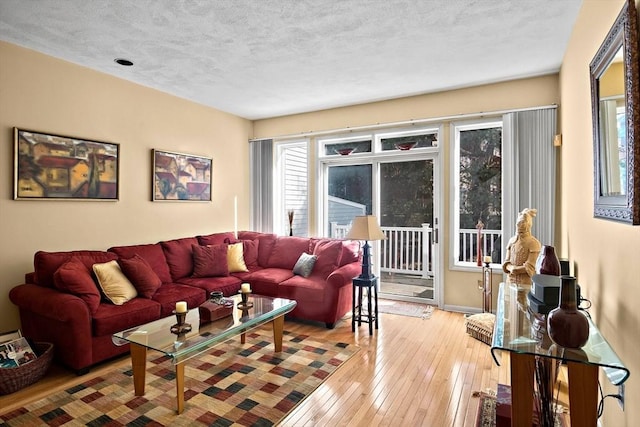 living area featuring a textured ceiling and light wood-type flooring