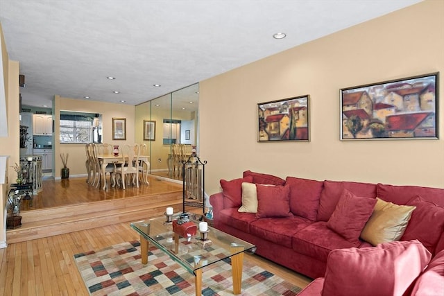 living area with recessed lighting, baseboards, and hardwood / wood-style floors