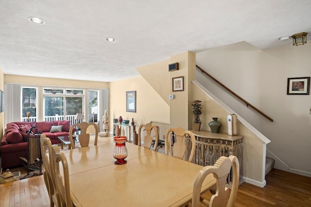 dining area featuring stairs, baseboards, wood finished floors, and recessed lighting