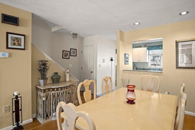 dining space featuring stairs, recessed lighting, baseboards, and wood finished floors