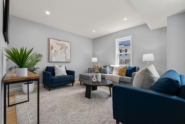 living room featuring recessed lighting, baseboards, and light wood-style flooring