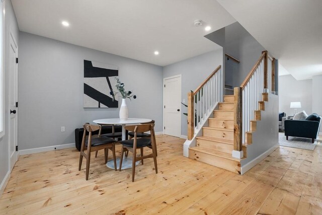 dining room with stairs, recessed lighting, and hardwood / wood-style floors