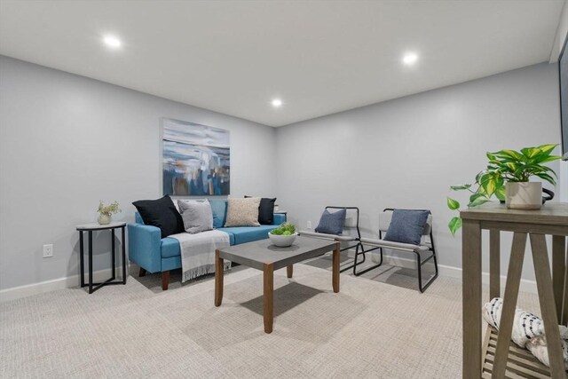 living room with recessed lighting, baseboards, and light colored carpet