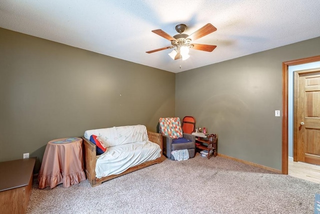 sitting room with ceiling fan and light carpet