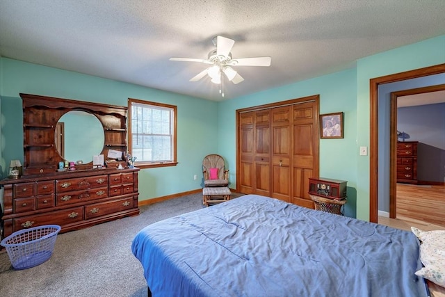 bedroom featuring ceiling fan, a closet, light carpet, and a textured ceiling