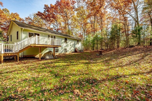 back of house with a lawn and a wooden deck