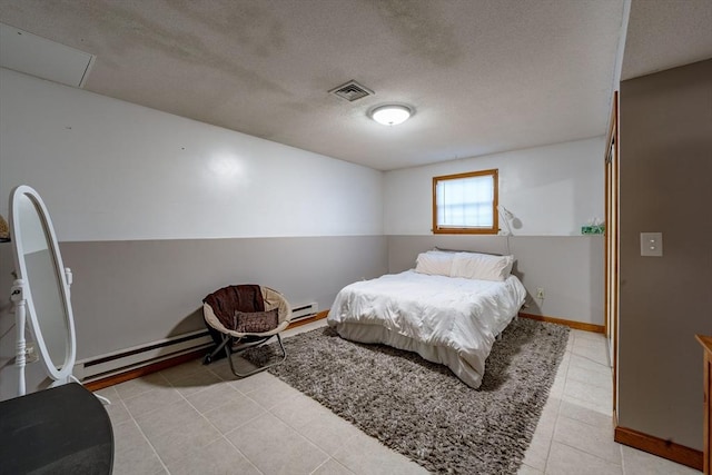 bedroom featuring baseboard heating and a textured ceiling