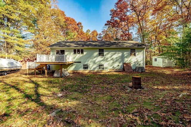 back of property featuring a wooden deck and a storage unit