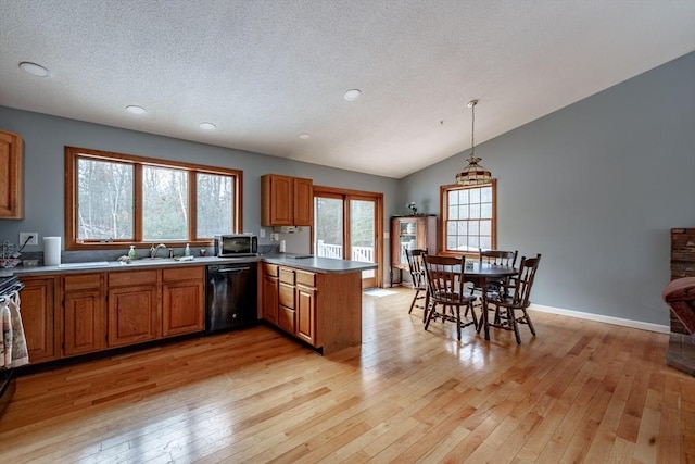 kitchen with dishwasher, pendant lighting, light wood-type flooring, and kitchen peninsula