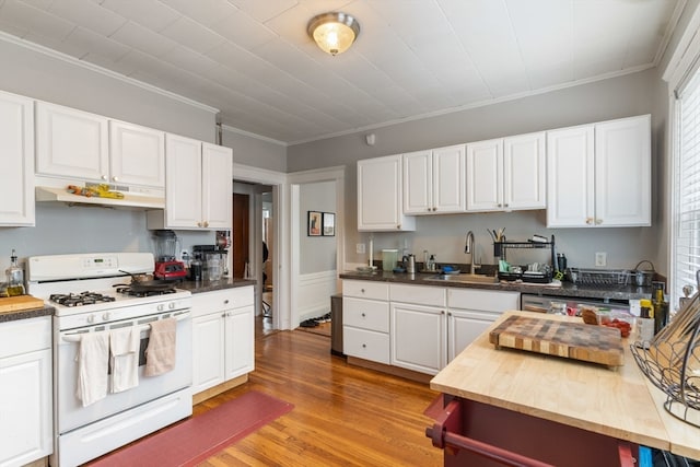 kitchen featuring white cabinetry, light hardwood / wood-style flooring, white gas stove, and sink