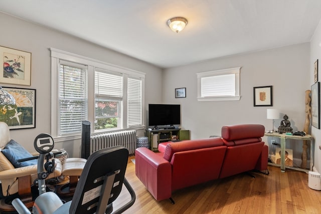 living room featuring radiator heating unit and light hardwood / wood-style floors