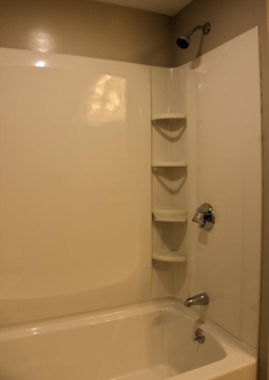 bathroom with bathing tub / shower combination