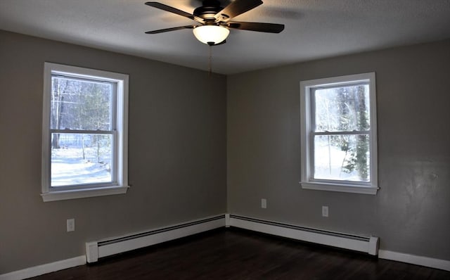 empty room with a healthy amount of sunlight, baseboards, and dark wood-style flooring