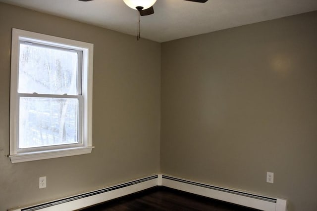 unfurnished room featuring a baseboard heating unit, dark wood-type flooring, and a ceiling fan