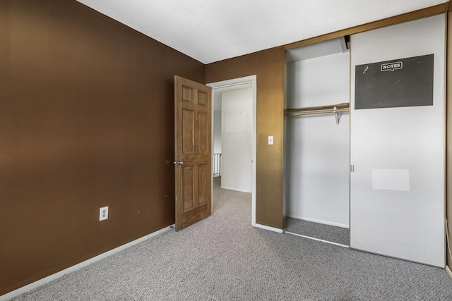 unfurnished bedroom featuring carpet flooring and a closet