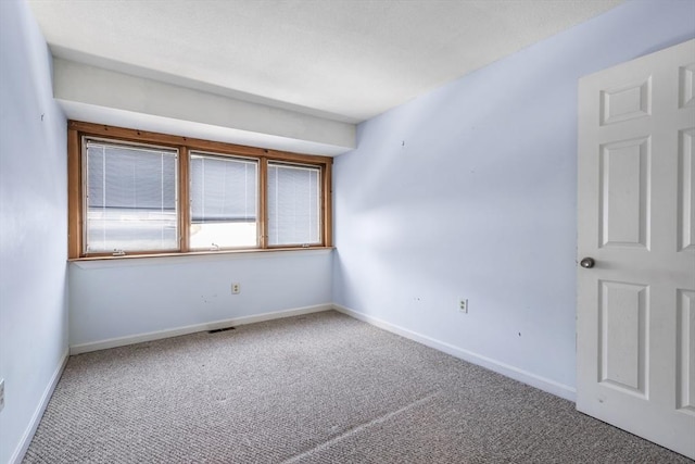 empty room featuring carpet flooring