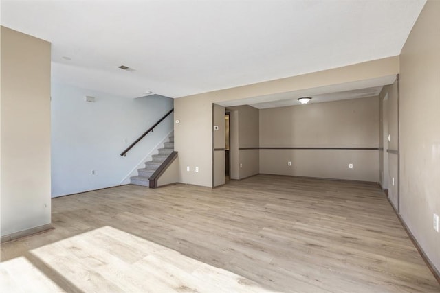 unfurnished room with light wood-type flooring