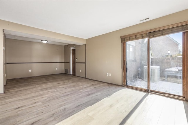 unfurnished room featuring light wood-type flooring