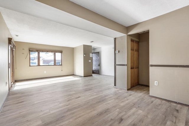 empty room with light hardwood / wood-style flooring