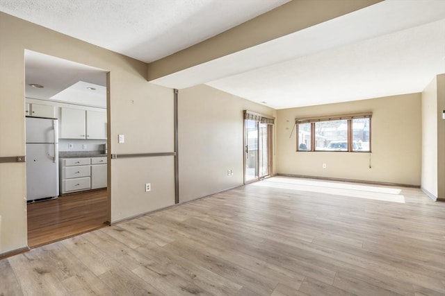 interior space featuring a textured ceiling and light hardwood / wood-style flooring