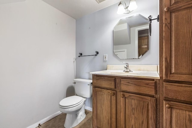 bathroom featuring vanity, tile patterned floors, and toilet