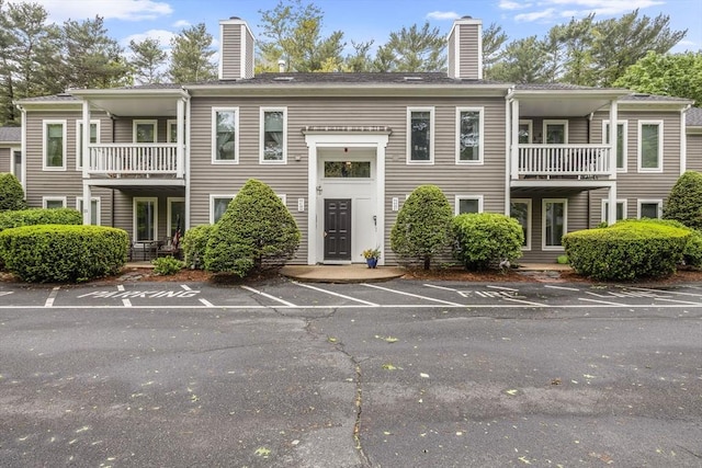 44 Bay Farm Rd Unit 44, Duxbury, MA 02332 - view of front facade with a balcony, a chimney, and uncovered parking