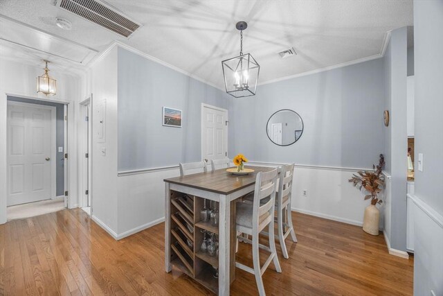 44 Bay Farm Rd Unit 44, Duxbury, MA 02332 - dining area with crown molding, wood finished floors, a chandelier, and baseboards