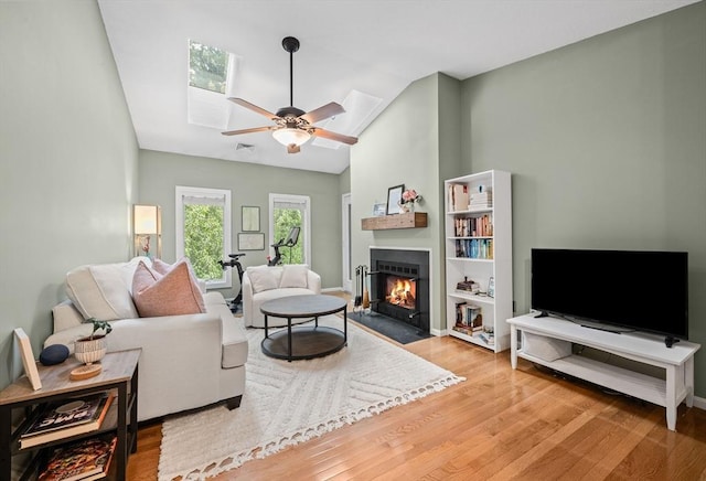 44 Bay Farm Rd Unit 44, Duxbury, MA 02332 - living area featuring wood finished floors, a fireplace with flush hearth, a ceiling fan, high vaulted ceiling, and baseboards