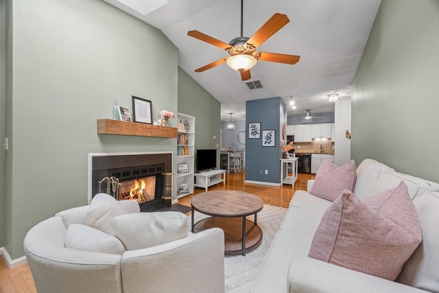 44 Bay Farm Rd Unit 44, Duxbury, MA 02332 - living room featuring ceiling fan, light wood finished floors, a fireplace with flush hearth, baseboards, and high vaulted ceiling