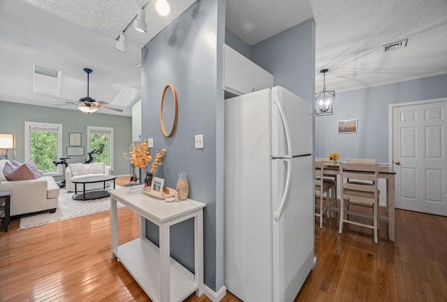 44 Bay Farm Rd Unit 44, Duxbury, MA 02332 - kitchen featuring freestanding refrigerator, ceiling fan, hardwood / wood-style flooring, white cabinets, and a textured ceiling